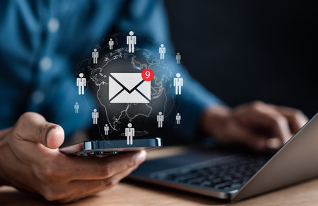 Businessman sending email by laptop computer to customer, business contact and communication, email icon, email marketing concept, send e-mail or newsletter, online working internet network.の写真素材