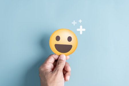 Hands holding blue happy smile face. mental health positive thinking and growth mindset concept.の写真素材