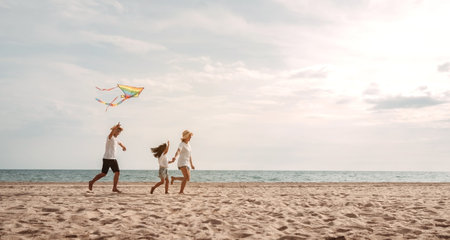 Happy asian family enjoy the sea beach. father, mother and daughter having fun playing beach in summer vacation on the ocean beach. Happy family with vacation time lifestyle concept.の写真素材