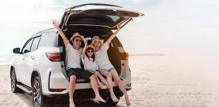 Family happy traveling enjoy in vacation with Car travel driving road trip summer vacation in car in the sunset, Dad, mom and daughter  holidays and relaxation together get the atmosphere.の写真素材