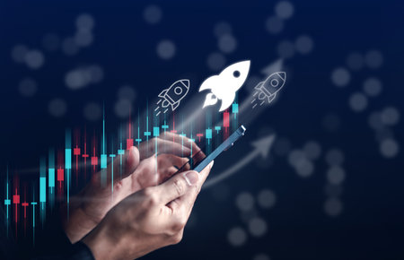 Businessman hold smart phone with rocket launch investment growth, planning and staring corporate...