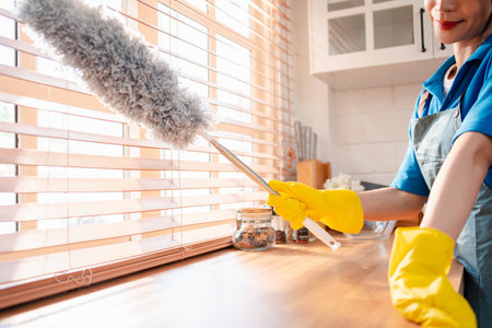 Housework or house keeping service female cleaning dust in house, cleaning agency small business. professional equipment cleaning old home.の写真素材