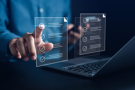 Online survey filling out and digital form checklist by laptop computer, Document Management Checking System, online documentation database and process manage files.の写真素材