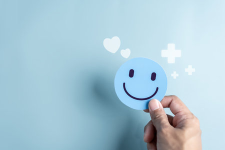 Hands hold Happy smile face. mental health positive thinking and growth mindset, mental health care recovery to happiness emotion.の写真素材