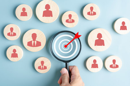 HRM or Human Resource Management, Magnifier glass focus to manager icon which is among staff icons for human development recruitment leadership and customer target group concept.の写真素材