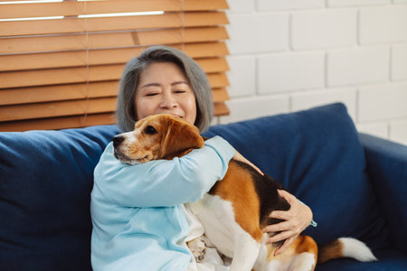 Happy asian senior woman retirement enjoying her dog pet in the home, Friendship pet and human lifestyle concept.の写真素材