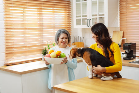 Happy asian senior woman retirement and daughter enjoying her dog pet in the home, Friendship pet and human lifestyle concept.の写真素材