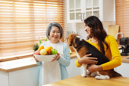 Happy asian senior woman retirement and daughter enjoying her dog pet in the home, Friendship pet and human lifestyle concept.の写真素材