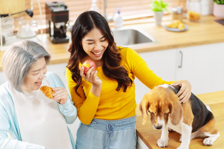 Happy asian senior woman retirement and daughter enjoying her dog pet in the home, Friendship pet and human lifestyle concept.の写真素材