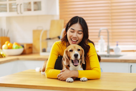 Happy asian woman enjoying her dog pet in the home, Friendship pet and human lifestyle concept.の写真素材