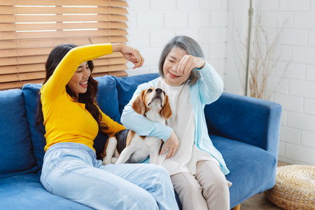 Happy asian senior woman retirement and daughter enjoying her dog pet in the home, Friendship pet and human lifestyle concept.の写真素材