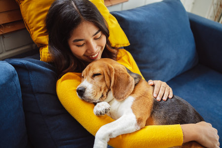 Happy asian woman enjoying her dog pet in the home, Friendship pet and human lifestyle concept.の写真素材