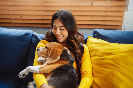 Happy asian woman enjoying her dog pet in the home, Friendship pet and human lifestyle concept.の写真素材