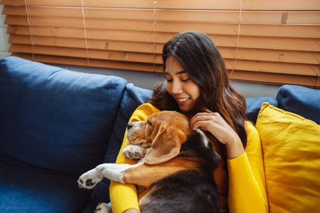Happy asian woman enjoying her dog pet in the home, Friendship pet and human lifestyle concept.の写真素材