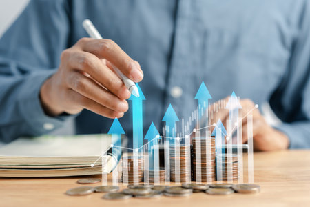 Businessman stacking money coins accounting for increase financial interest rate and business investment growth from dividend, Business Finance and Money, Save money for prepare in the future.の写真素材