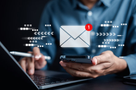 Businessman sending email by laptop computer to customer, business contact and communication, email icon, email marketing conceptの写真素材