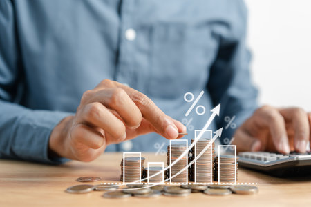 Businessman stacking money coins accounting for increase financial interest rate and business investment growth from dividend, Business Finance and Money, Save money for prepare in the future.の写真素材