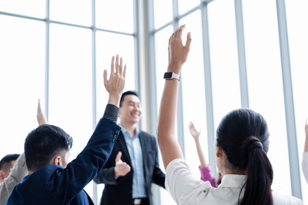 Business person raising hand during seminar. Hand up in conference asking to answer a question in business meeting room and seminar class.の写真素材