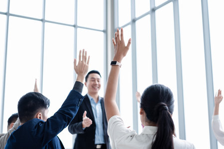 Business person raising hand during seminar. Hand up in conference asking to answer a question in business meeting room and seminar class.の写真素材