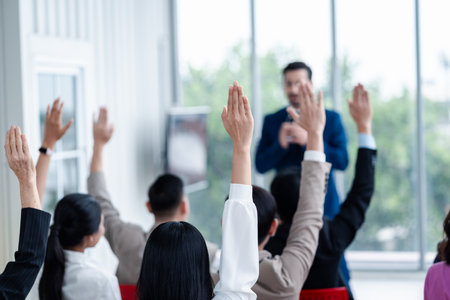 Business person raising hand during seminar. Hand up in conference asking to answer a question in business meeting room and seminar class.の写真素材