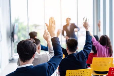 Business person raising hand during seminar. Hand up in conference asking to answer a question in business meeting room and seminar class.の写真素材