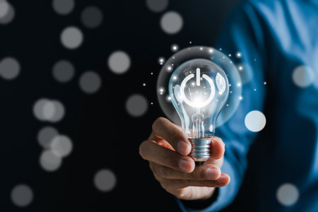 Man hand holding lightbulb start new idea and learning educate and graduation concept. study knowledge to creative thinking idea and problem solving solution in corporate business strategy.の写真素材