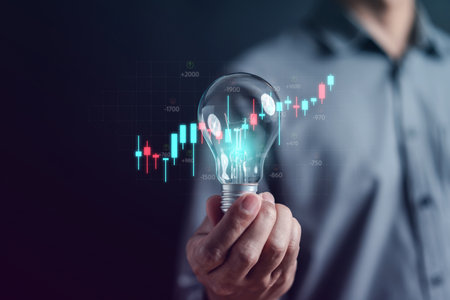Man hand holding lightbulb start new idea for trading in stock market exchange investment growth and business strategy.の写真素材