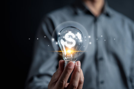 Man hand holding lightbulb start new idea make money in business and learning educate and graduation concept. study knowledge to creative thinking idea and problem solving solutionの写真素材