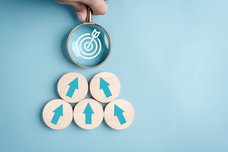 Business growth success achievement concept, arranging wooden block stacking with magnifier focus to target as step stair or ladder for planning customer group development concept.の写真素材