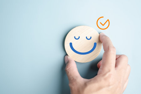 Hands holding blue happy smile face. mental health positive check up and growth mindset, mental health care recovery to happiness emotion.の写真素材
