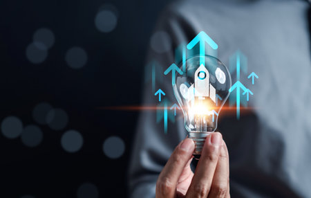 Business growth journey of a rocket launch inside light bulb, Arrow accelerate towards to goals, rapid startup momentum. sights are set on achieving success, forward with determination and innovation.の写真素材