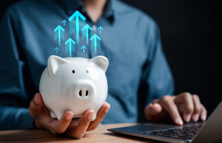 Businessman saving money coin in piggy bank for growth to success goal. Funds and stock Invest profits. assets, wealth, lucrative. investment and retirement concept.の写真素材