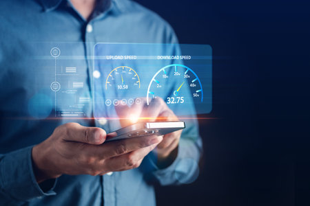 High performance speed internet connection network technology, Man using Internet high speed by smartphone and laptop computer, 5G quality, speed optimization with fiber optic.の写真素材