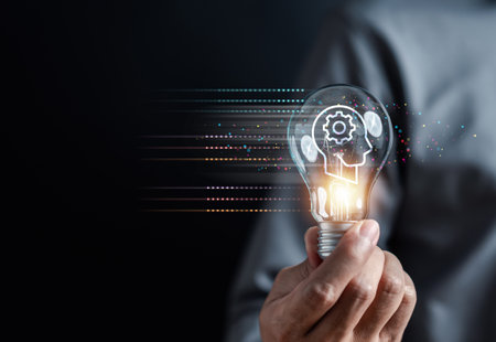 Hand man holding illuminated lightbulb, idea, innovation and inspiration with glowing virtual brain, smart intelligent creativity with bulbs, Motivation and innovation concept.の写真素材
