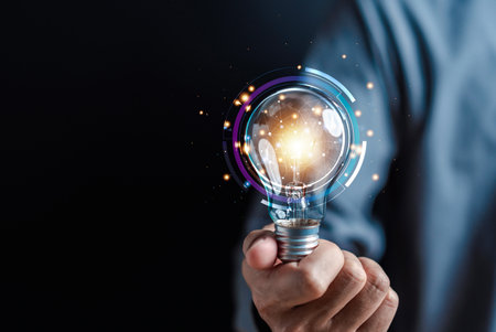 Hand man holding illuminated lightbulb, idea, innovation and inspiration with glowing virtual brain, smart intelligent creativity with bulbs, Motivation and innovation concept.の写真素材