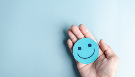 Hands holding happy smile face for medical care concept. mental health positive thinking.の写真素材