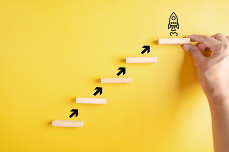 Business growth success achievement concept, hand of people arranging as step stair or ladder rocketship launch for planning development leadership and customer target group concept.の写真素材