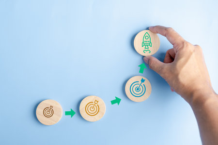 Hand holding objective aiming target and rocket ship launch arrow up to leadership and customer target group for start business to goal achievement.の写真素材