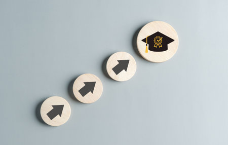 Steps of education leading to success goal. Taking strategic steps towards graduation. Career path and first for business, Graduation achievement goals concept. Graduation cap on wooden block.の写真素材