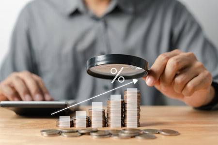 Businessman stacking money coins accounting for increase financial interest rate and business investment growth from dividend, Business Finance and Money, Save money for prepare in the future.の写真素材