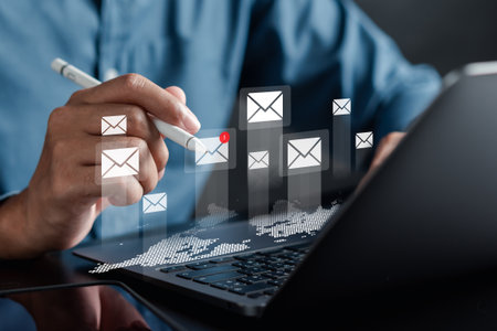 Businessman sending email by laptop and smartphone to customer, business contact and communication, email icon, email marketing concept, send e-mail or newsletter, online working internet network.の写真素材