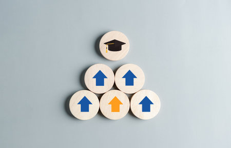 Steps of education leading to success goal. Taking strategic steps towards graduation. Career path and first for business, Graduation achievement goals concept. Graduation cap on wooden block.の写真素材