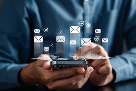 Businessman sending email by laptop and smartphone to customer, business contact and communication, email icon, email marketing concept, send e-mail or newsletter, online working internet network.の写真素材