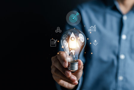 Rocket launch idea inside lightbulb with arrows up. strategically planning and initiating a corporate startup. aim to achieve objectives through value development, fostering leadership.の写真素材