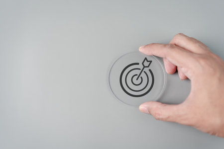 Hand holding Target icon which for planning development leadership and customer target group concept.の写真素材