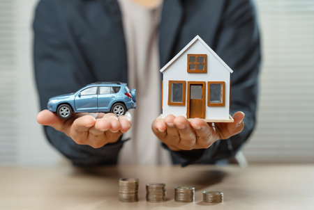 Insurance financial agent signing services to promote and sell insurance and car. man agent insurance calculate money for deals in buy or sell house and car.の写真素材