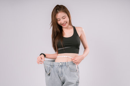 Sport Weight Loss Fitness Woman Body Fit Health Waist Slim, Confident Female Embracing a Healthy Lifestyle and Slim Figure On White Backgroundの写真素材