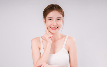 Skin Care Woman Asian Person Smile White Beauty Young Portrait Face Background, Confident and Radiant Female Model with Healthy Skin On White Backgroundの写真素材