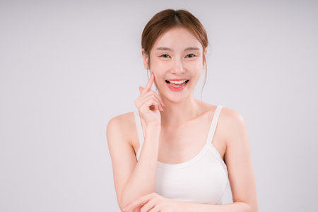 Skin Care Woman Asian Person Smile White Beauty Young Portrait Face Background, Confident and Radiant Female Model with Healthy Skin On White Backgroundの写真素材