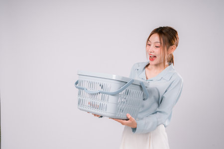 Woman Basket Supermarket Order Purchase Package Retail Choice Customer Enjoy, Happy Young Woman Holding a Basket, Enjoying Her Shopping Experience with Smart Choices and a Smileの写真素材